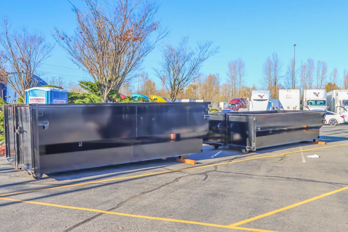 Professional dumpster rental service with roll-off container on residential driveway in High Springs